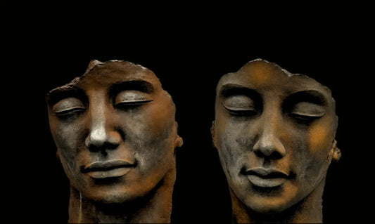 mans face carved on black surface