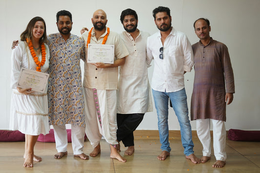 A group of six people posing for a photo indoors.